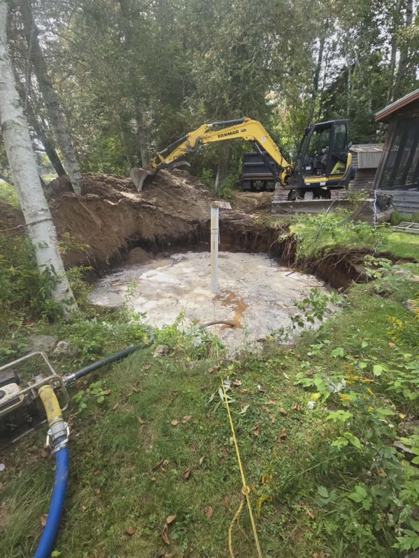 Excavation and sand bed next to a cottage