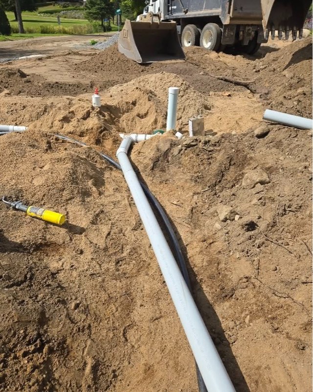 Drain pipes and a cleanout in a trench